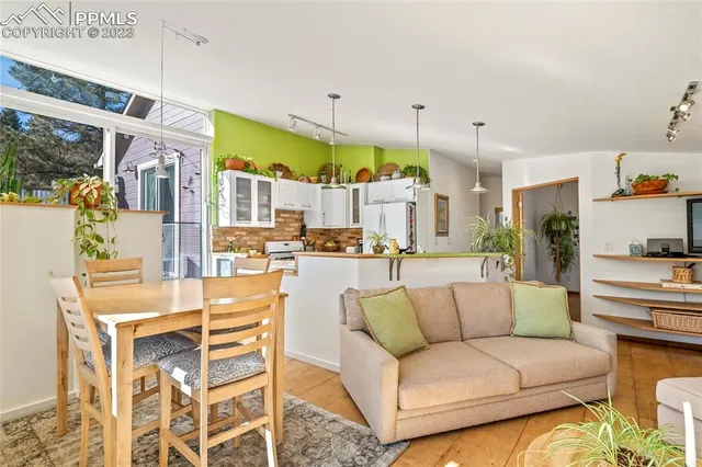 a view of a living room kitchen and a dining table
