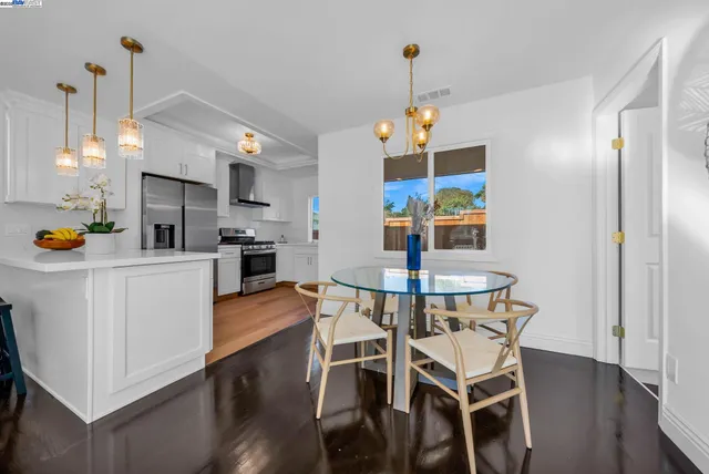 a kitchen with stainless steel appliances a stove a refrigerator and a sink