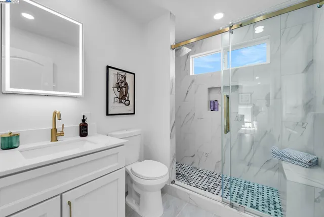 a bathroom with a toilet sink and mirror
