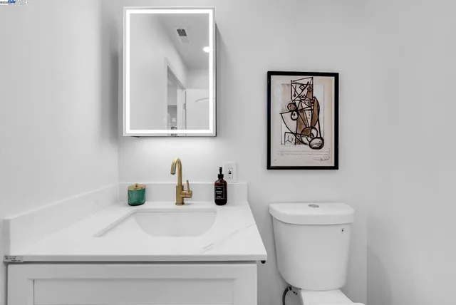 a bed room with a bed and a chair