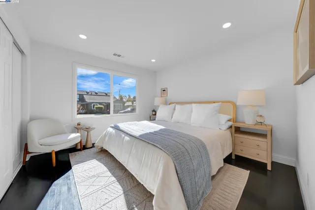 a bedroom with a large bed and a large window