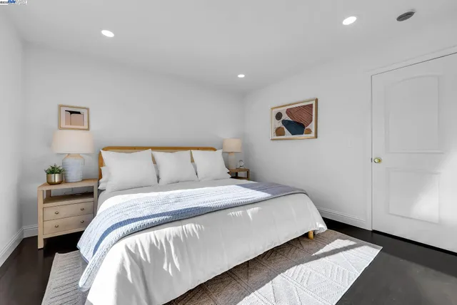 a bedroom with a bed and a painting on the wall