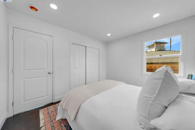 a bedroom with a large bed and a large window