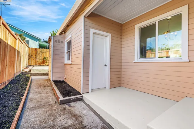 a backyard of a house with table and chairs