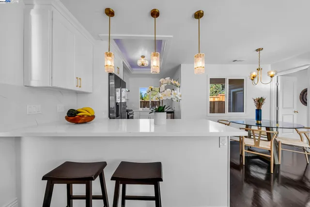 a kitchen with stainless steel appliances granite countertop a sink a stove and a wooden floors