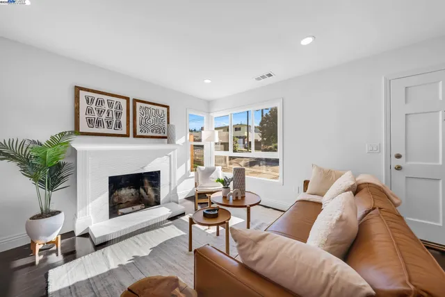 a living room with furniture and a fireplace