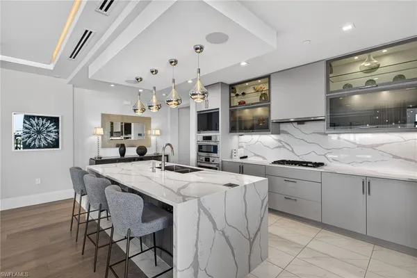 a kitchen with stainless steel appliances kitchen island granite countertop a sink and cabinets