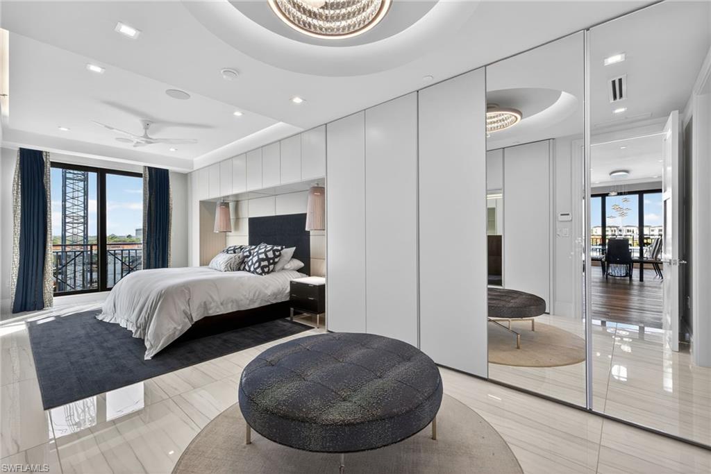 1135 3rd Avenue South, Unit 521 Naples, FL 34102 - Photo 12 of 39 a bedroom with a large bed and a couch