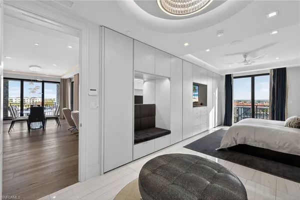 a bedroom with a bed and a large mirror