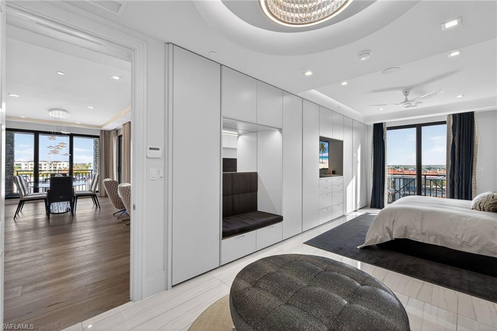 1135 3rd Avenue South, Unit 521 Naples, FL 34102 - Photo 13 of 39 a bedroom with a bed and a large mirror