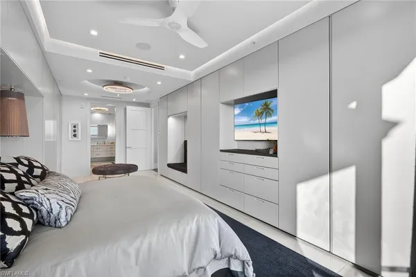a bedroom with a bed and a large mirror