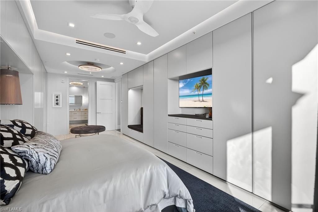 1135 3rd Avenue South, Unit 521 Naples, FL 34102 - Photo 14 of 39 a bedroom with a bed and a large mirror