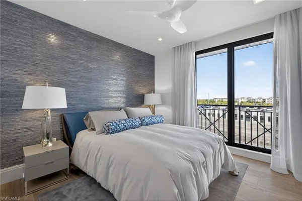 a bedroom with a large bed and a lamp