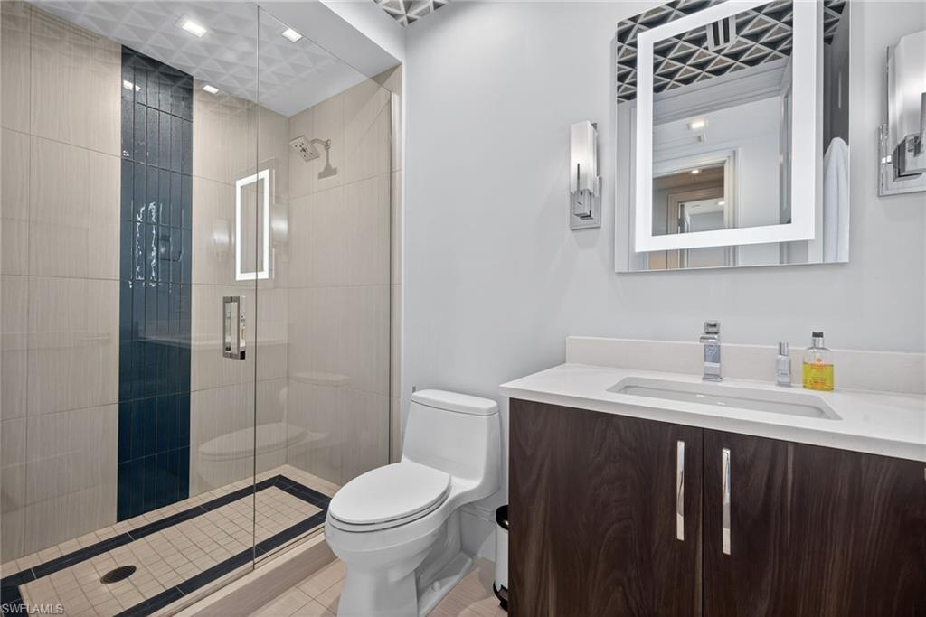 1135 3rd Avenue South, Unit 521 Naples, FL 34102 - Photo 18 of 39 a bathroom with a sink a toilet and shower