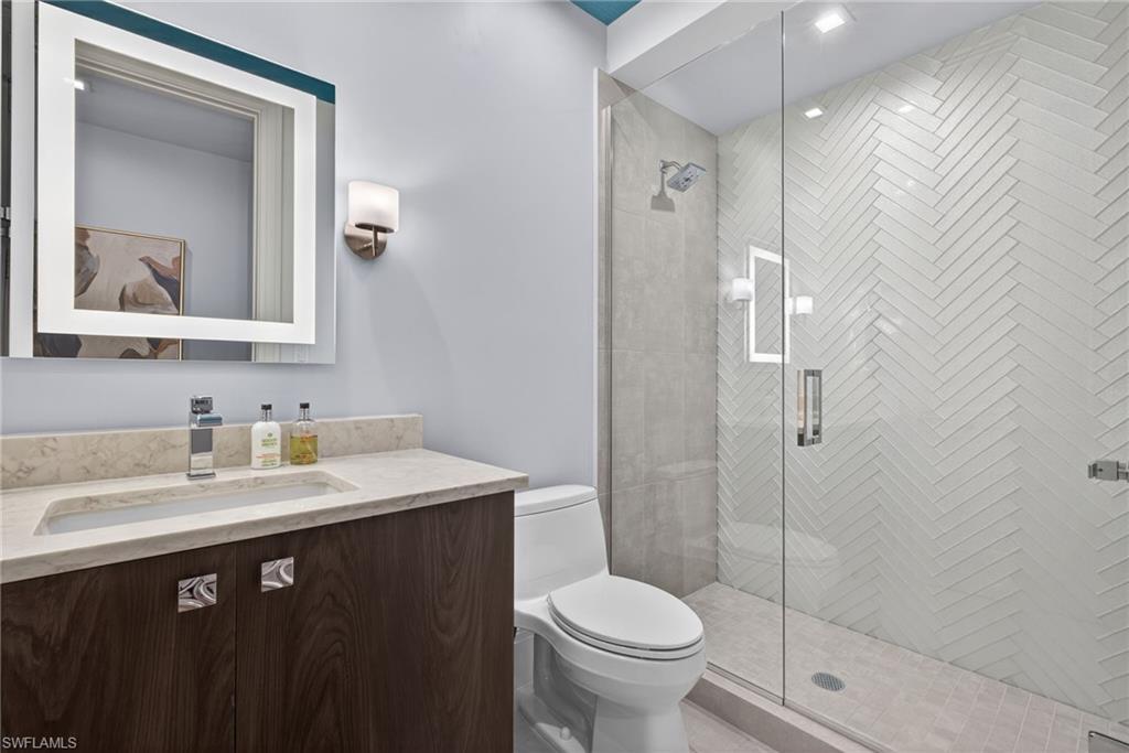 1135 3rd Avenue South, Unit 521 Naples, FL 34102 - Photo 20 of 39 a bathroom with a sink a toilet and shower