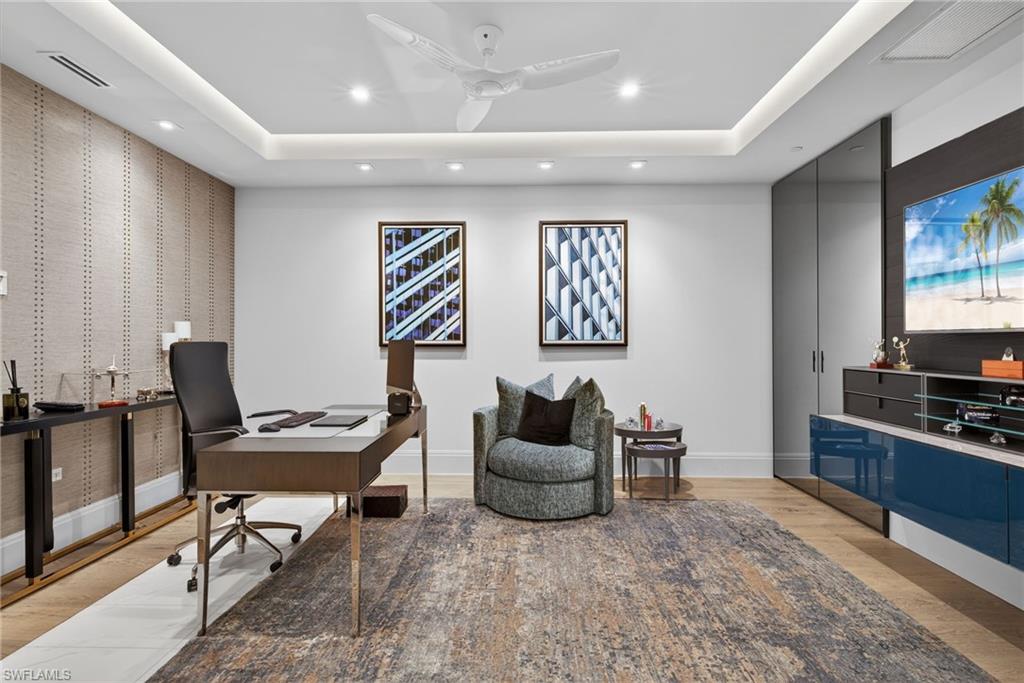 1135 3rd Avenue South, Unit 521 Naples, FL 34102 - Photo 21 of 39 a living room with furniture a flat screen tv and kitchen view