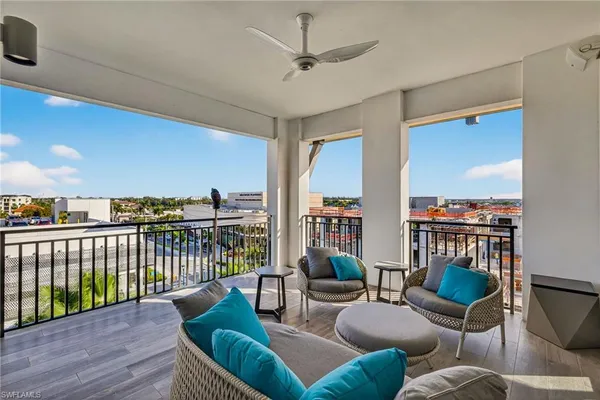 a living room with furniture a ceiling fan and a rug