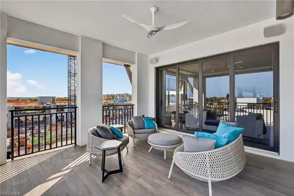 a living room with furniture and a floor to ceiling window
