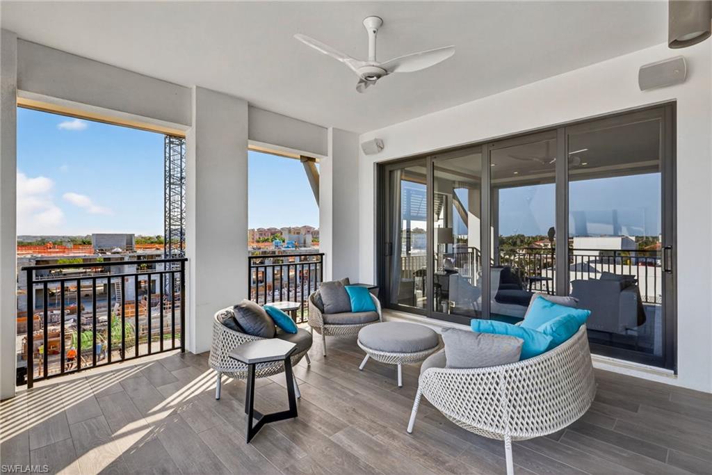 1135 3rd Avenue South, Unit 521 Naples, FL 34102 - Photo 27 of 39 a living room with furniture and a floor to ceiling window