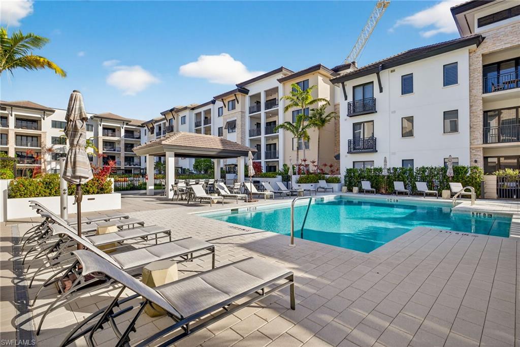 1135 3rd Avenue South, Unit 521 Naples, FL 34102 - Photo 30 of 39 a view of a building with a garden and sitting area