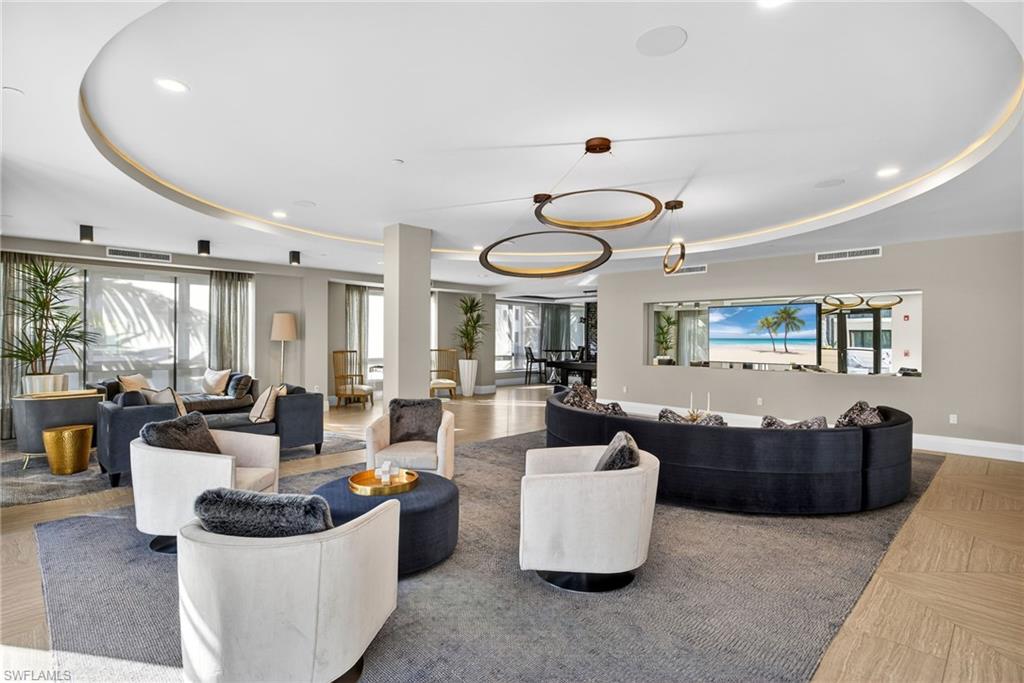 1135 3rd Avenue South, Unit 521 Naples, FL 34102 - Photo 33 of 39 a living room with furniture and a large window