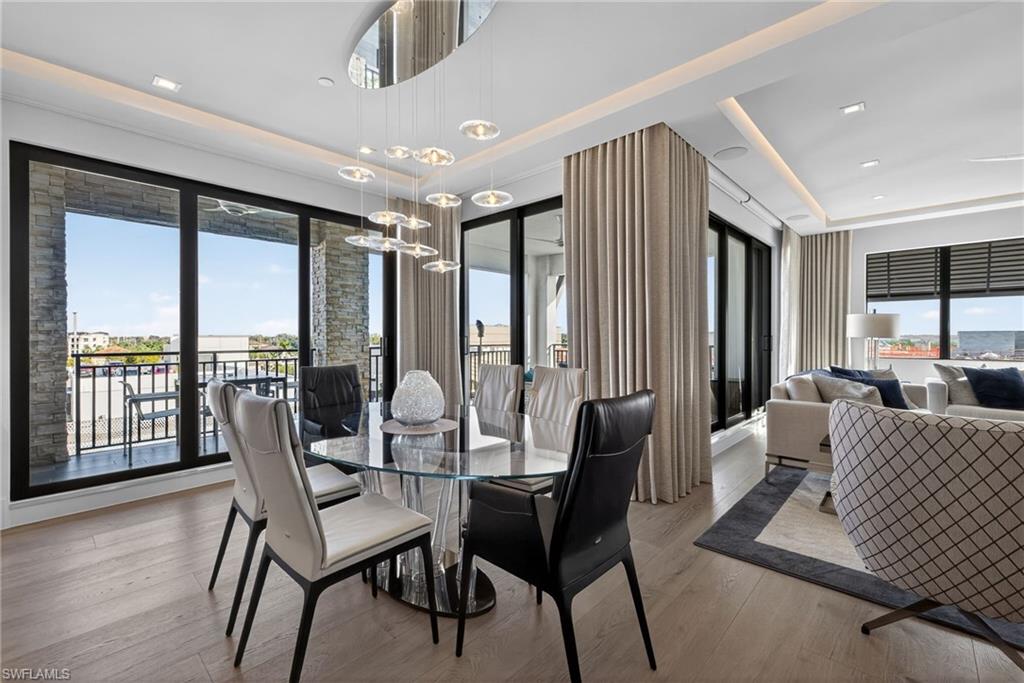 1135 3rd Avenue South, Unit 521 Naples, FL 34102 - Photo 5 of 39 a living room with furniture and a large window