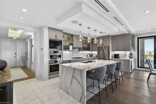 a kitchen with stainless steel appliances kitchen island granite countertop a sink and cabinets