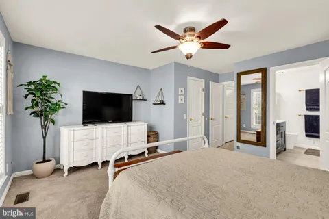 a bedroom with furniture and a flat screen tv