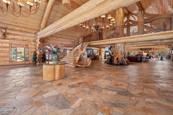 a living room with lots of furniture and a ceiling fan