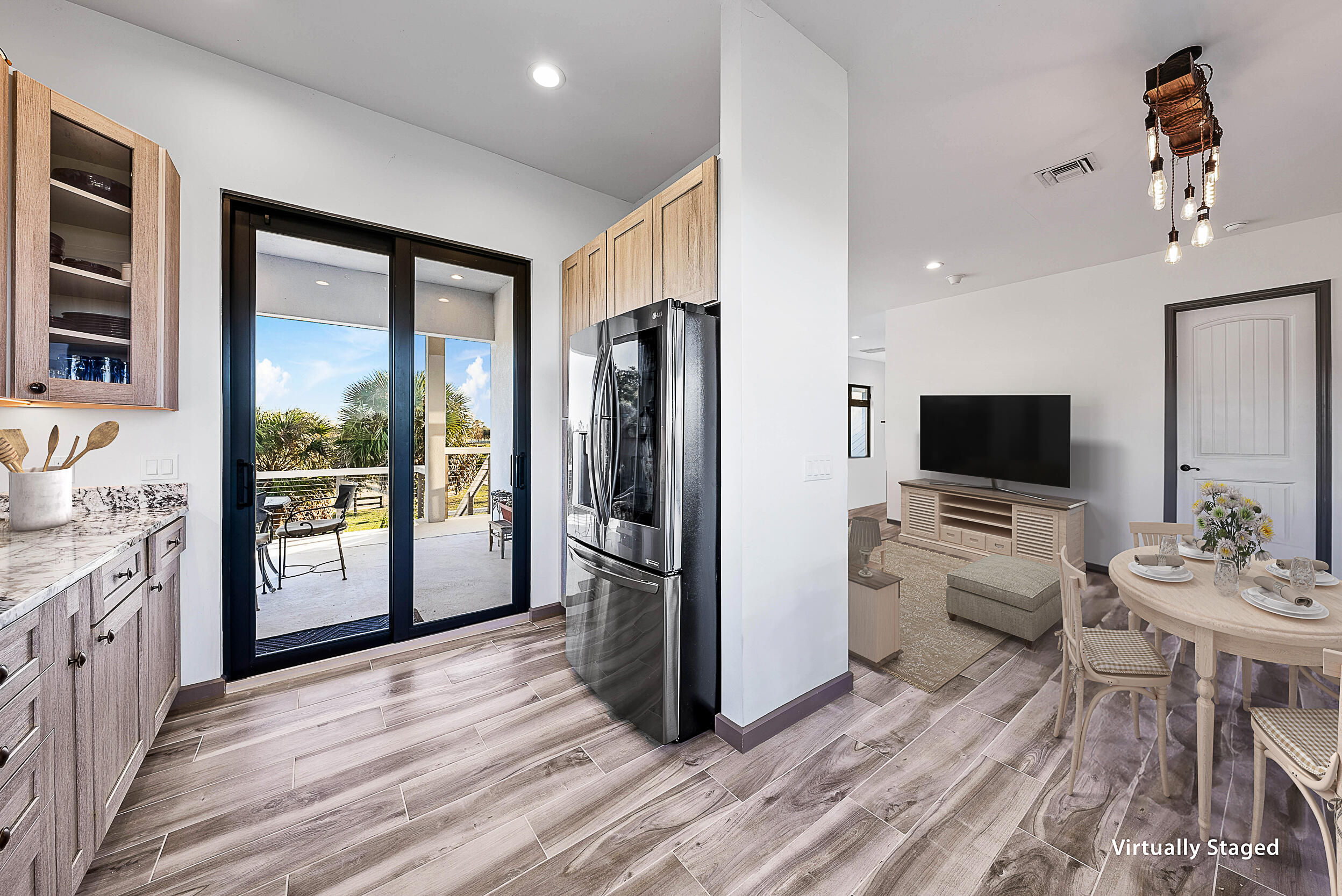 2986 Southwest Trailside Path Stuart, FL 34997 - Photo 11 of 40 a living room with stainless steel appliances furniture a flat screen tv and a refrigerator