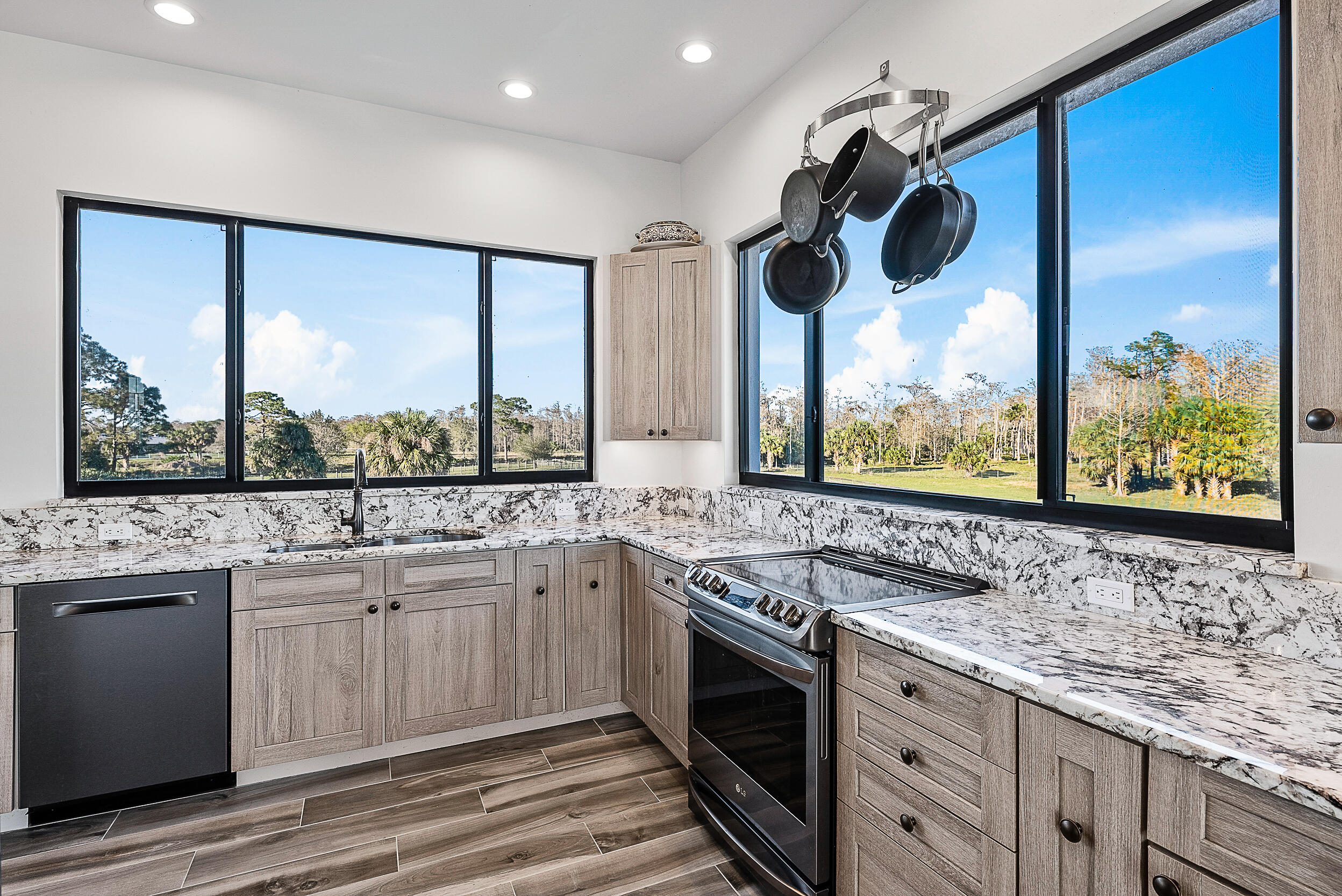 2986 Southwest Trailside Path Stuart, FL 34997 - Photo 11 of 40 a kitchen with stainless steel appliances granite countertop a sink and window