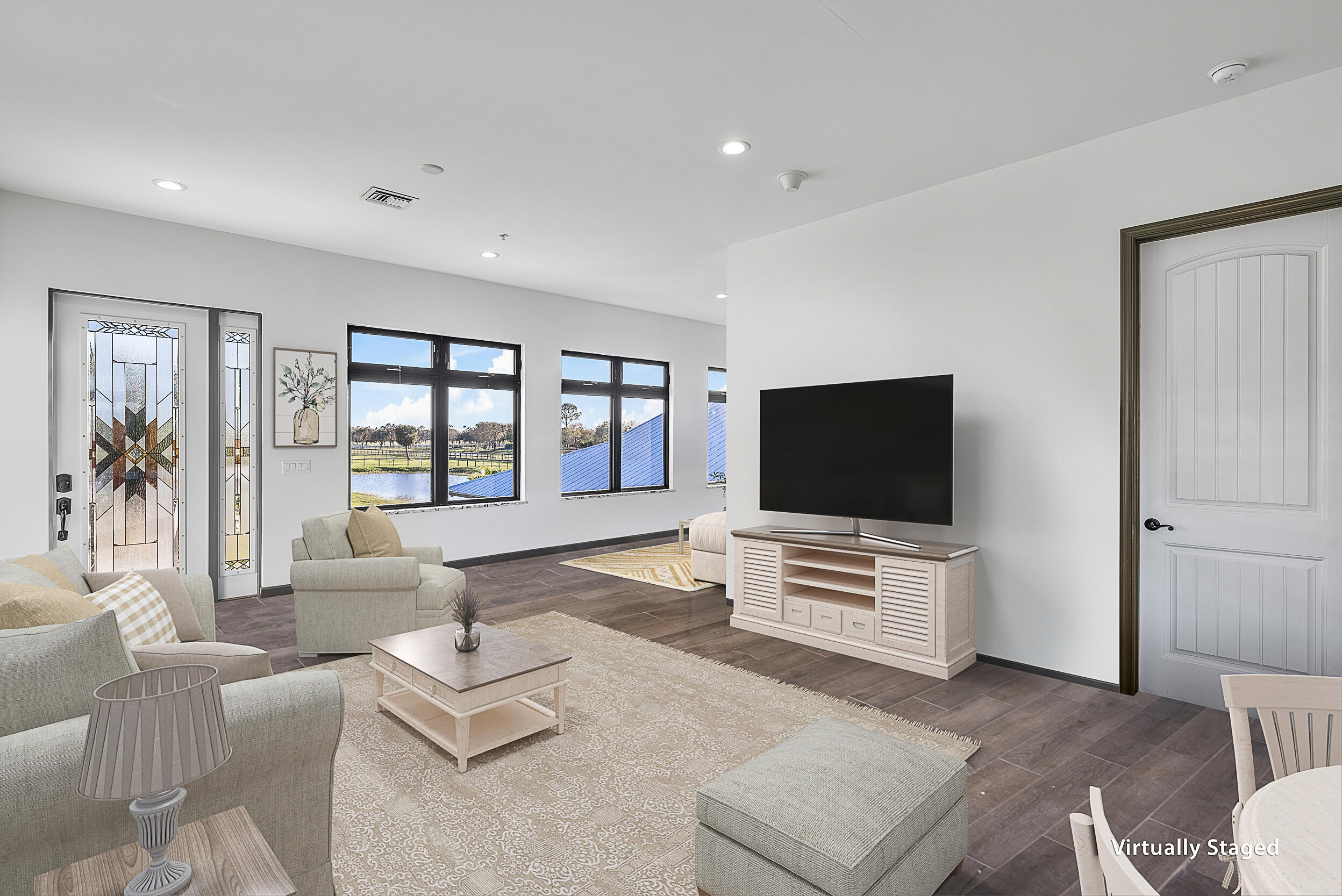 2986 Southwest Trailside Path Stuart, FL 34997 - Photo 12 of 40 a living room with furniture and a flat screen tv