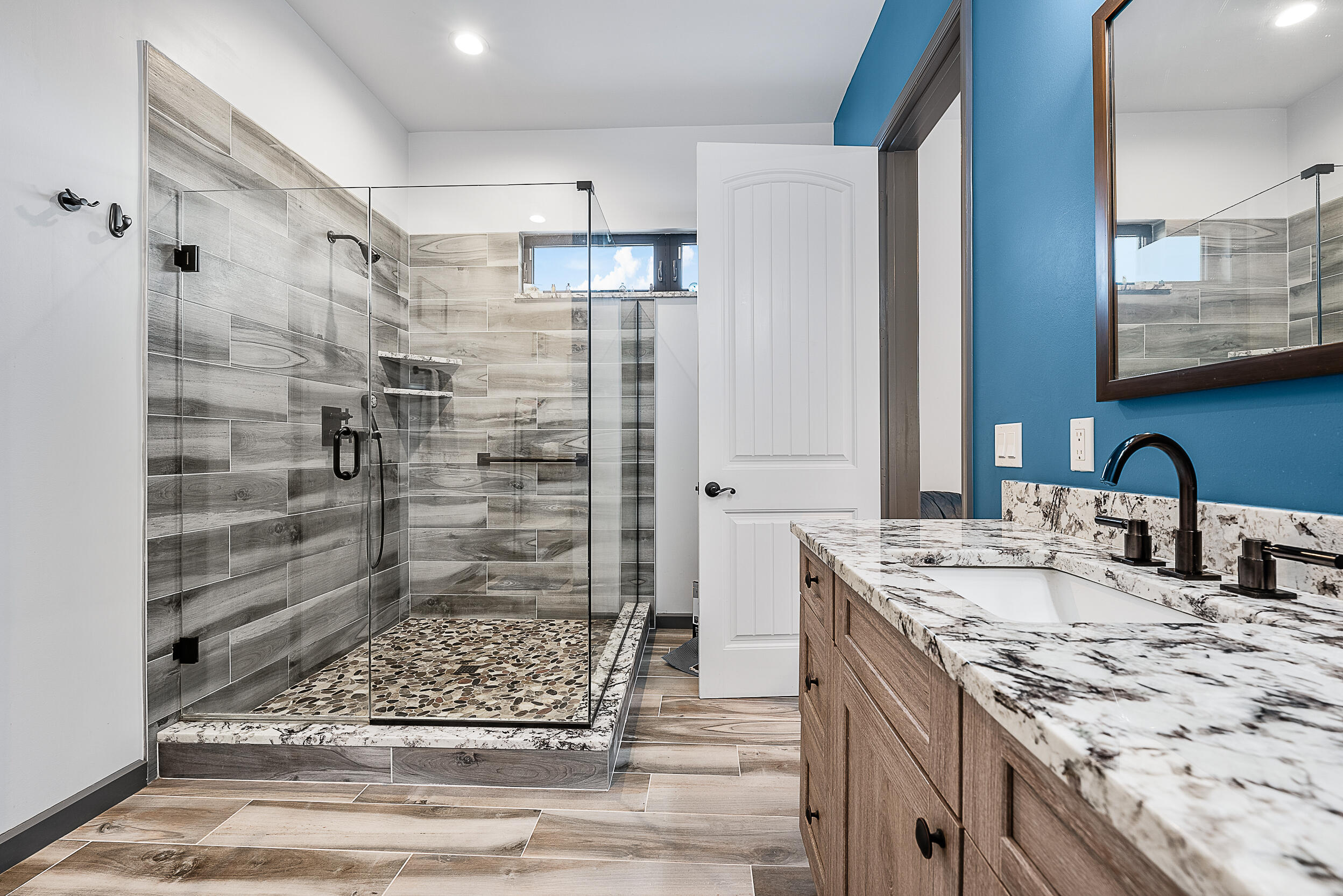 2986 Southwest Trailside Path Stuart, FL 34997 - Photo 15 of 40 a bathroom with a granite countertop sink mirror and shower
