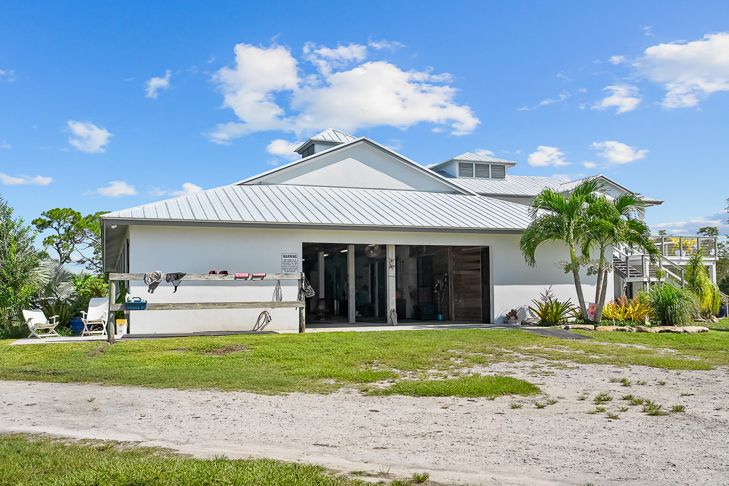 2986 Southwest Trailside Path Stuart, FL 34997 - Photo 23 of 40 a view of a white house with a yard and plants