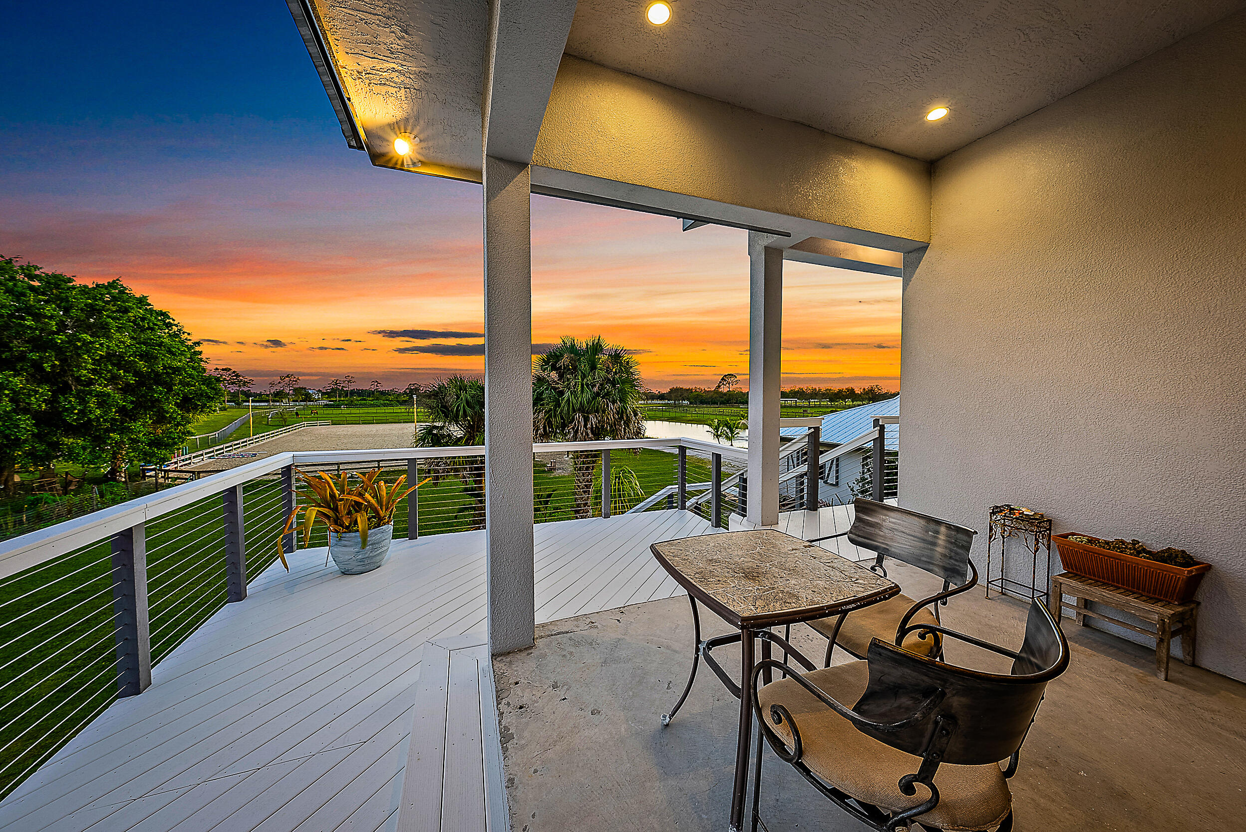 2986 Southwest Trailside Path Stuart, FL 34997 - Photo 8 of 40 a view of a balcony with table and chairs and wooden floor
