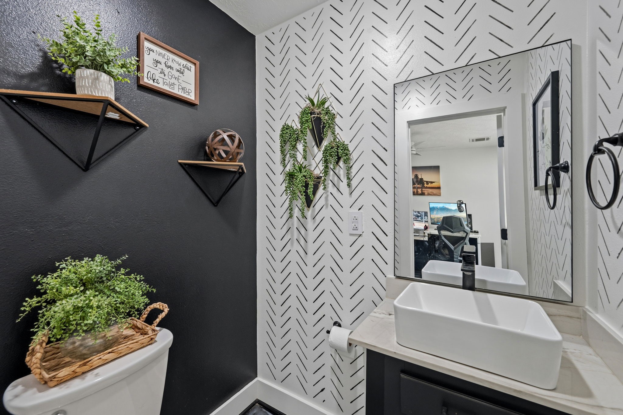 18 East Old Field Road Huffman, TX 77336 - Photo 7 of 35 Elegant powder bath located in the home office is enhanced by striking painted wall floating shelves, stylish lighting, & sophisticated decorative accents that create a polished look.