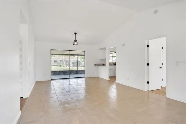 a view of kitchen with refrigerator and window