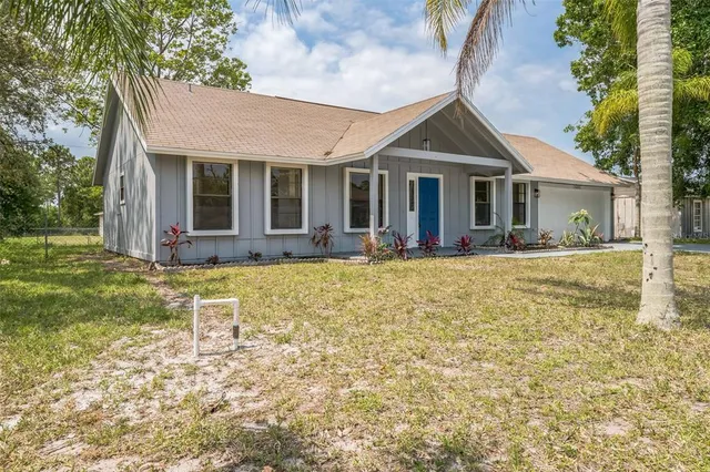 a front view of a house with a yard table and chairs