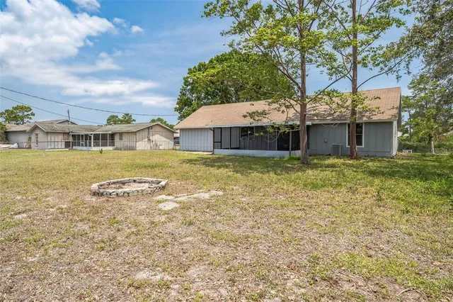 a view of a house with a yard and sitting area