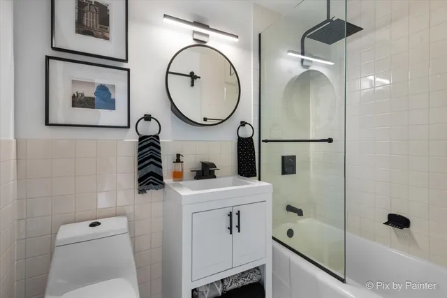 a bathroom with a sink a toilet and a mirror