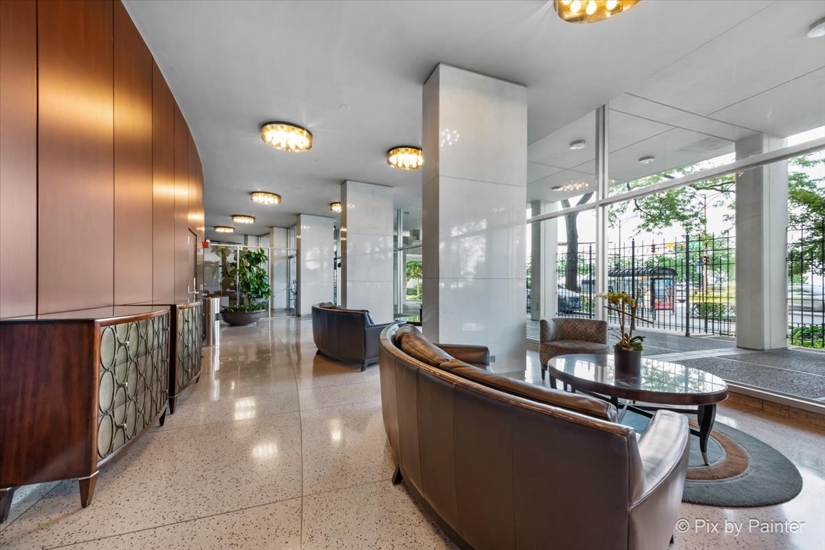1150 North Lake Shore Drive, Unit 19A Chicago, IL 60611 - Photo 33 of 34 a lobby with furniture and floor to ceiling window