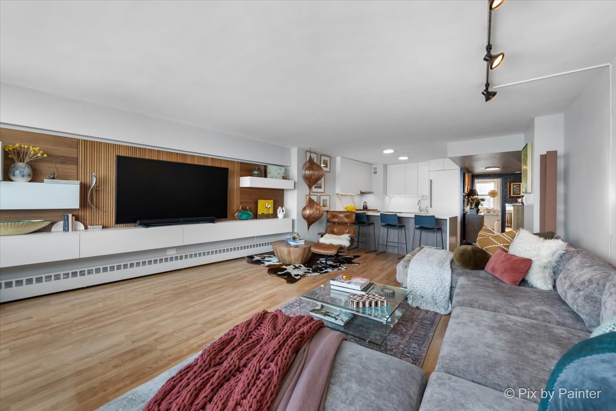 1150 North Lake Shore Drive, Unit 19A Chicago, IL 60611 - Photo 4 of 34 a living room with furniture and a flat screen tv
