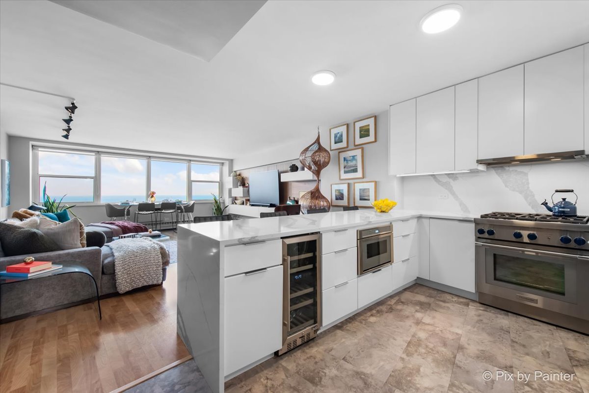 1150 North Lake Shore Drive, Unit 19A Chicago, IL 60611 - Photo 6 of 34 a kitchen with stainless steel appliances granite countertop a stove a sink and a refrigerator