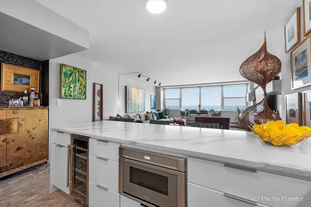 a kitchen with stainless steel appliances granite countertop a stove and cabinets