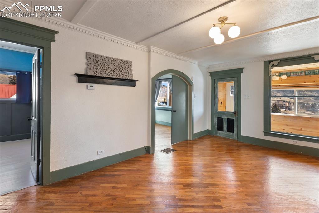 123 7th Street Victor, CO 80860 - Photo 12 of 44 a view of a hallway with wooden floor and a dining room