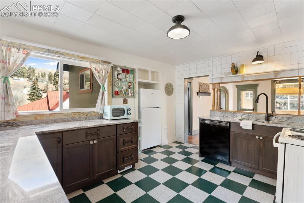 123 7th Street Victor, CO 80860 - Photo 13 of 44 a kitchen with a sink stove and refrigerator