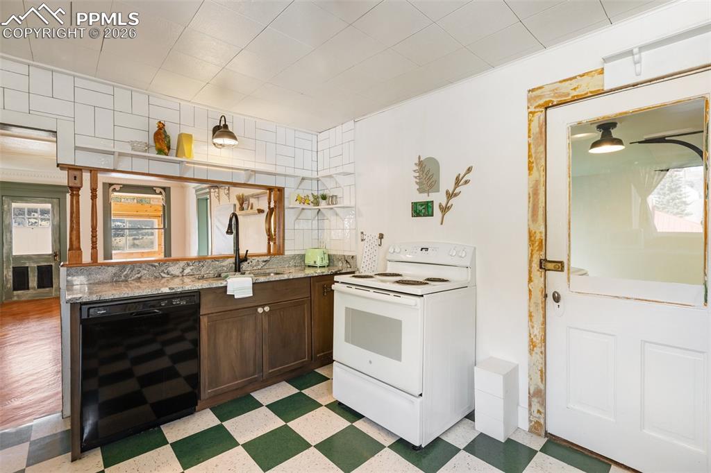 123 7th Street Victor, CO 80860 - Photo 14 of 44 a kitchen with stainless steel appliances a stove a sink and a refrigerator