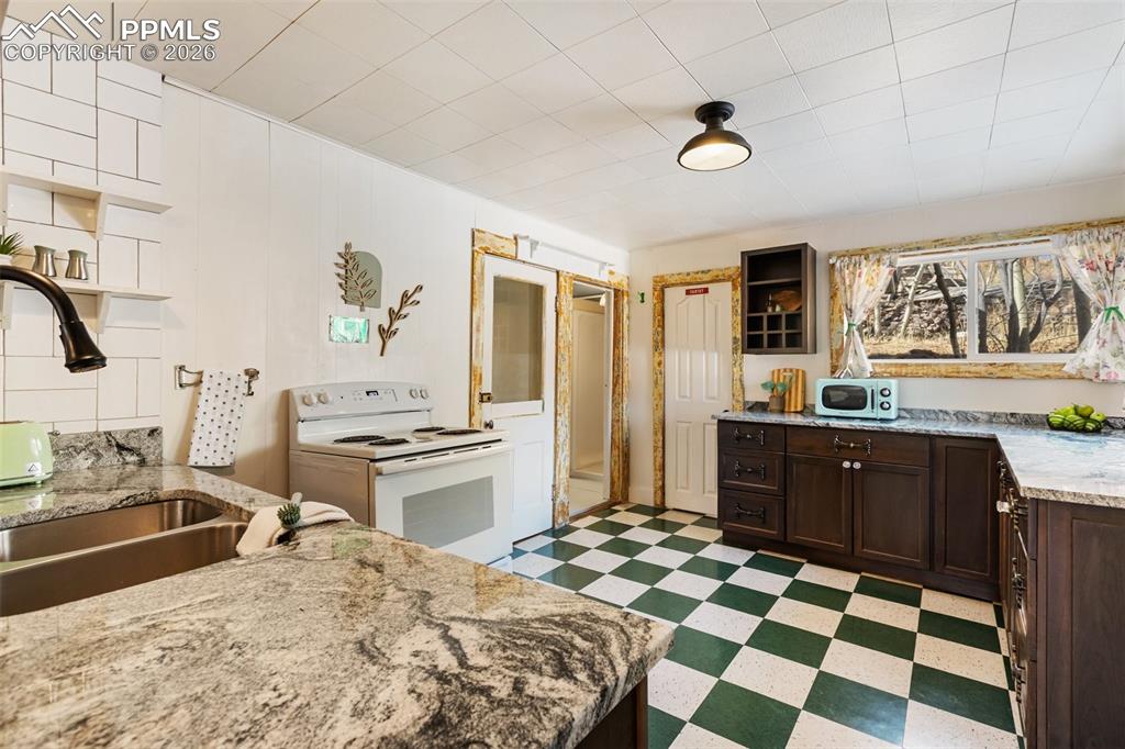 123 7th Street Victor, CO 80860 - Photo 15 of 44 a kitchen with a sink stove and refrigerator