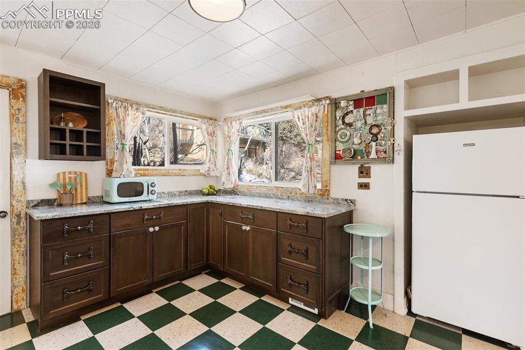 123 7th Street Victor, CO 80860 - Photo 16 of 44 a kitchen with stainless steel appliances granite countertop a refrigerator and a sink