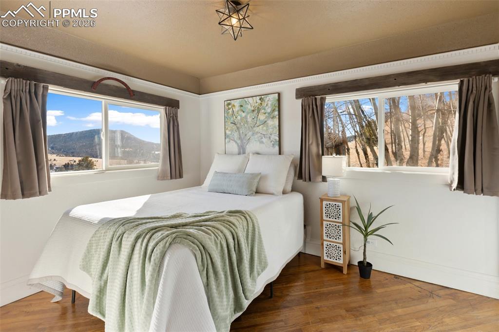 123 7th Street Victor, CO 80860 - Photo 18 of 44 a bedroom with a large bed and a window